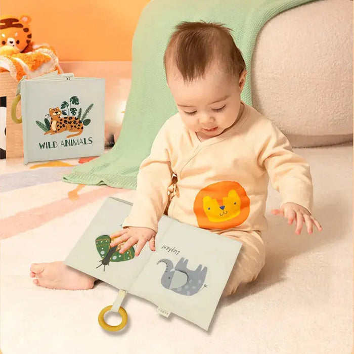 A cotton fabric baby book with a ring attached